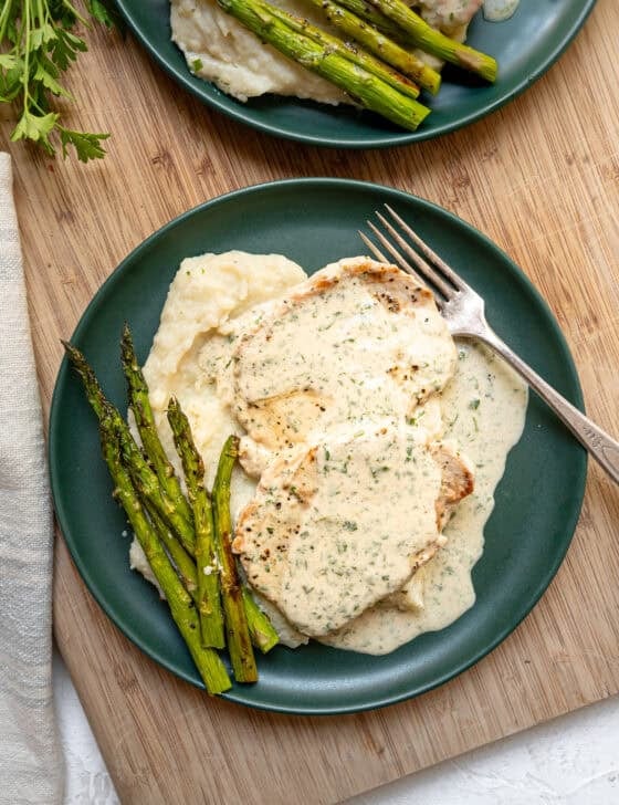 Mashed potatoes with boneless pork chops and Boursin gravy on top.