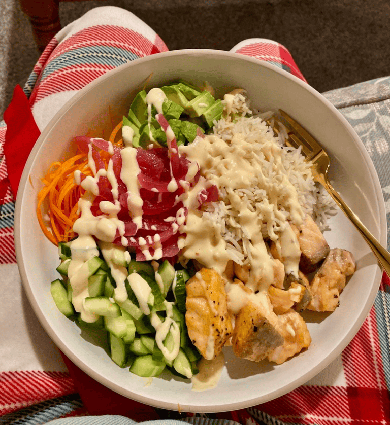 Salmon Bowl with Bang Bang Sauce in lap