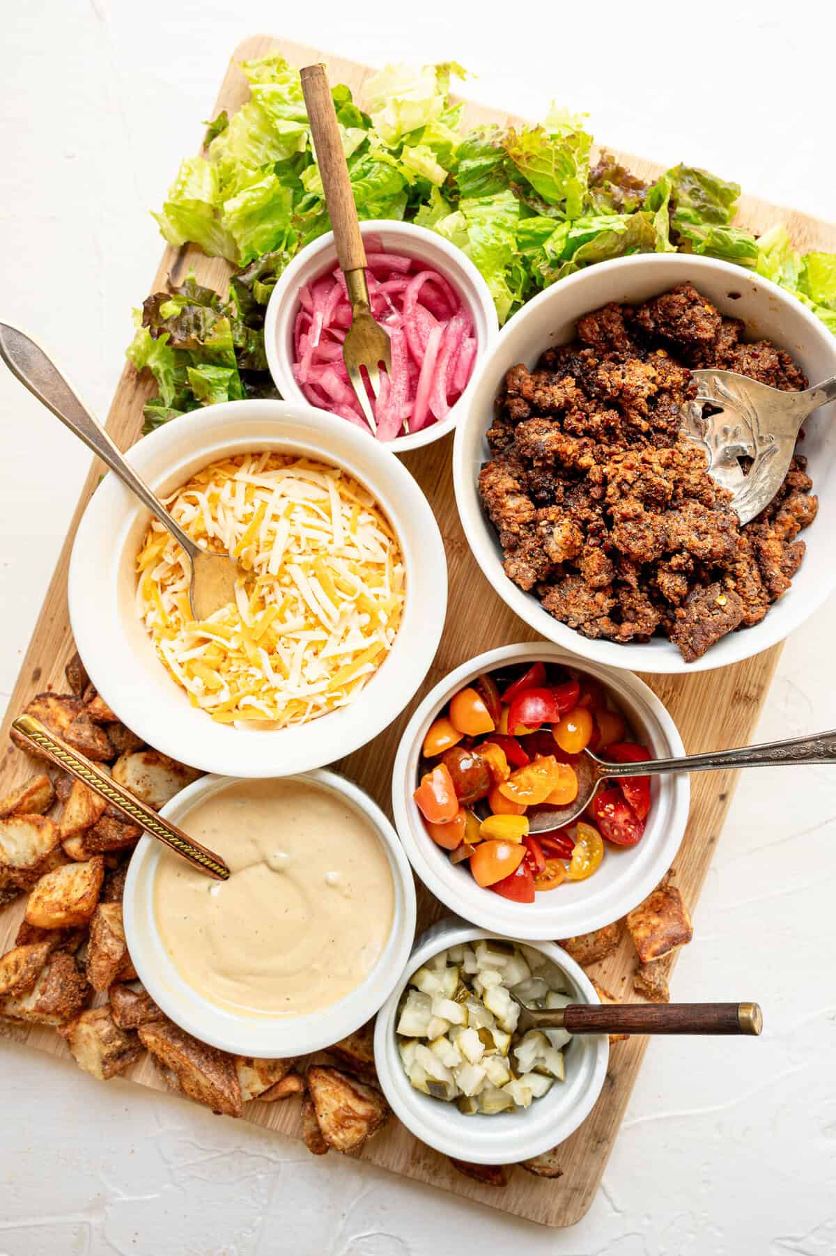 Ingredients for cheeseburger bowls with secret sauce laid out for everyone to make their own.