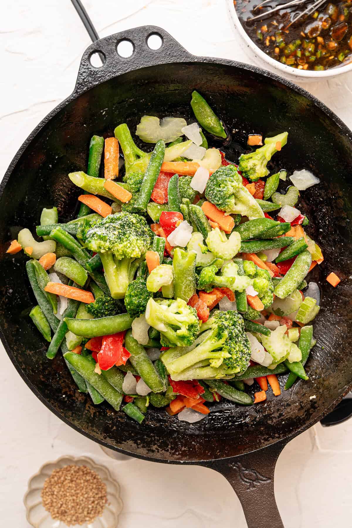 Frozen stir fry veggies dumped from the product bag straight into a hot cast iron skillet.